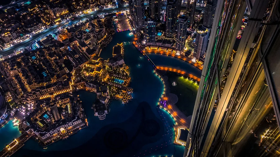 Aerial night view of Dubai from Burj Khalifa, illustrating a travel guide to Dubai.