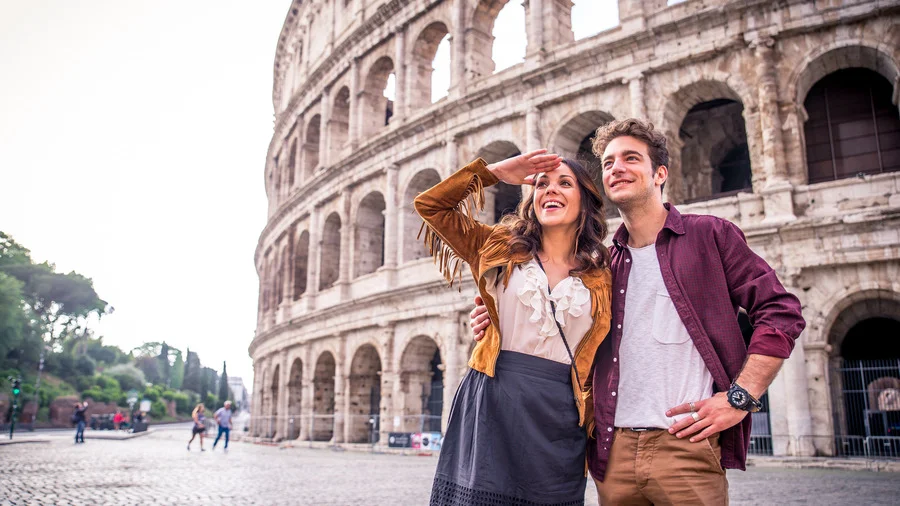 Tourist couple enjoying a visit to the Colosseum in Rome