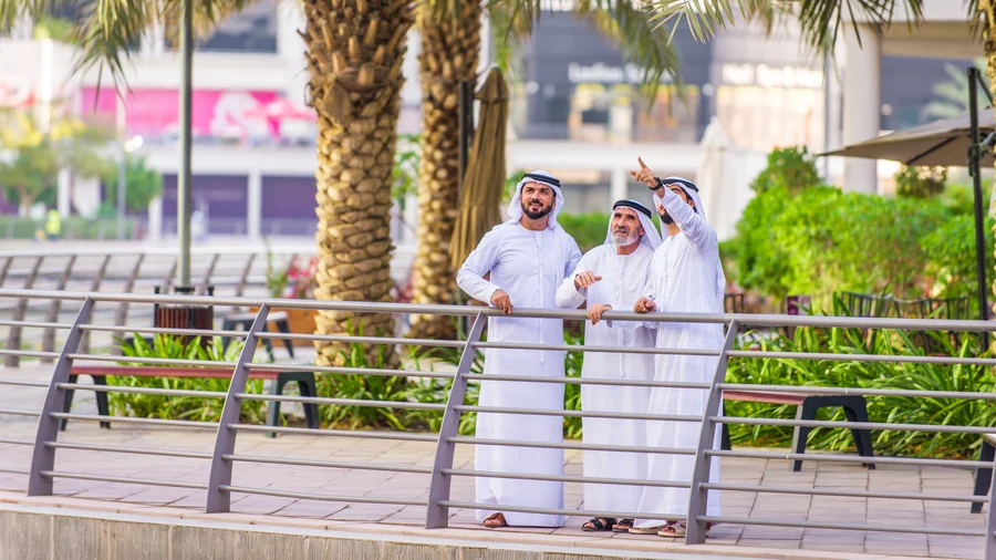 Group of businessmen discussing in Dubai, highlighting the business travel aspect of a Dubai travel guide.