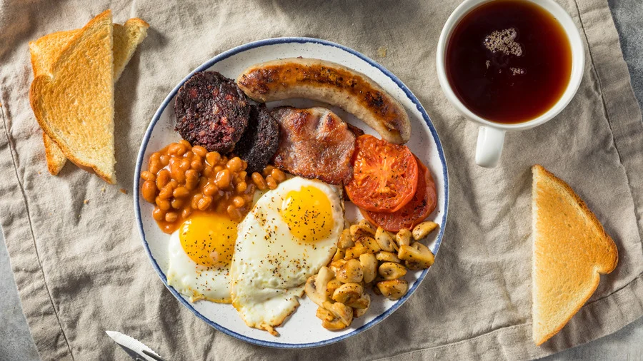 Full English Breakfast with eggs and sausage served in London