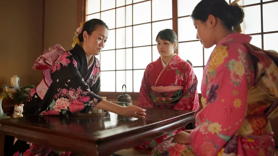 Japanese women in traditional kimonos performing a tea ceremony in a Chashitsu room in Tokyo.