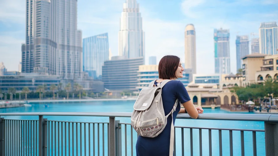 Young woman with backpack enjoying Dubai downtown view