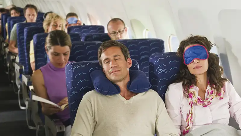 Passengers sleeping peacefully in economy class air travel