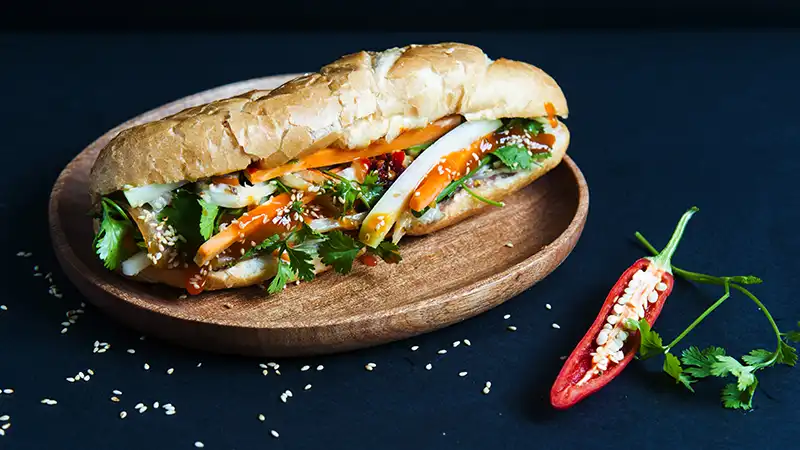 Delicious Vietnamese Banh Mi sandwich with fresh vegetables and meats.