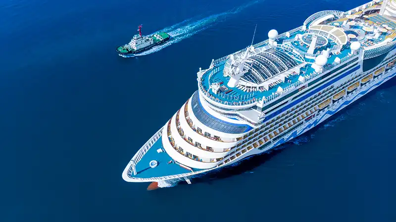 Aerial view of a luxurious white cruise ship, ideal for the best cruise experience for young adults.