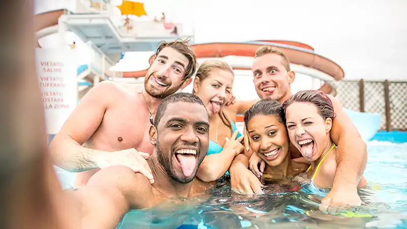 Young adults enjoying a pool party on a cruise ship, epitomizing the best cruise experience for young adults.