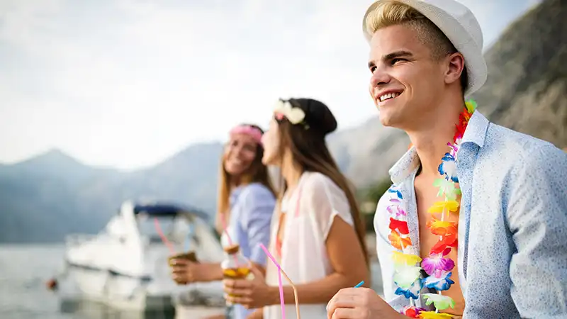 Joyful group of young adults enjoying a summer party, reminiscent of the fun on the best cruises for young adults.