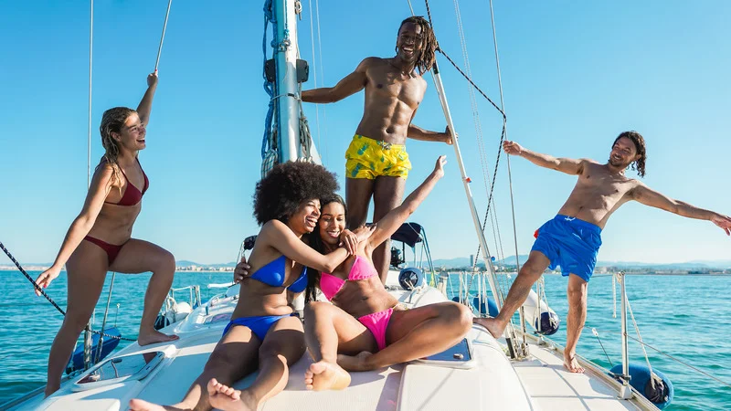Friends enjoying a sunny day on a rented yacht in Cancun, complete with a captain and crew.