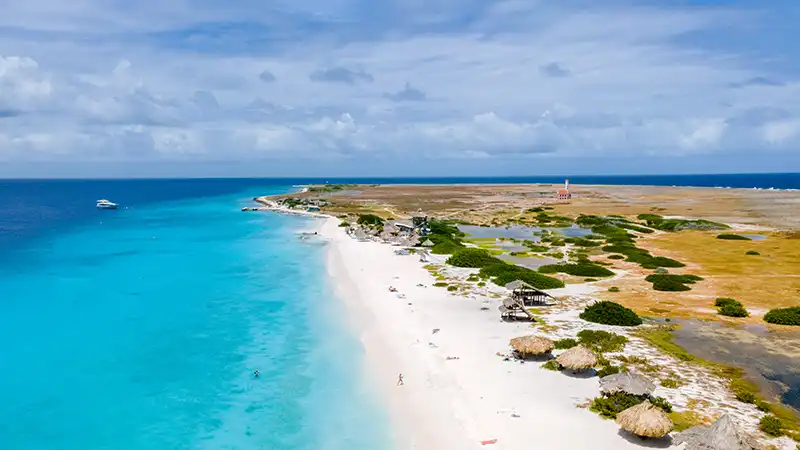 Klein Curacao island showing a tropical beach, a prime destination for all-inclusive vacations with airfare.