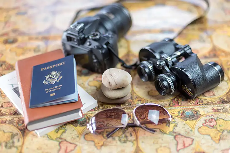 A comprehensive travel preparedness kit including maps, compass, and essential gear for adventure.